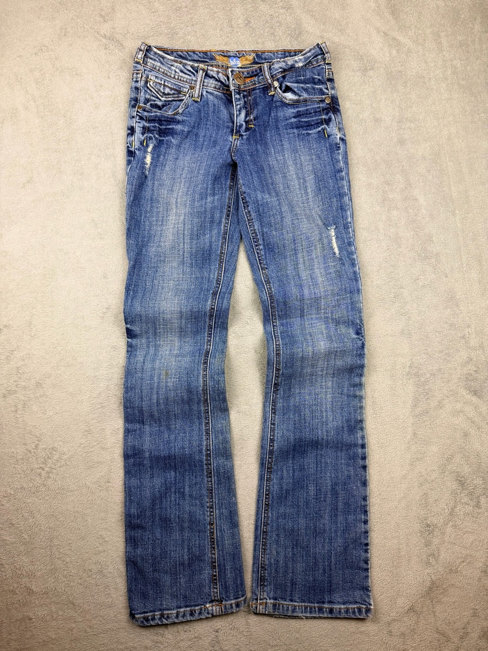 Womenโs Blue Distressed Bootcut Jeans